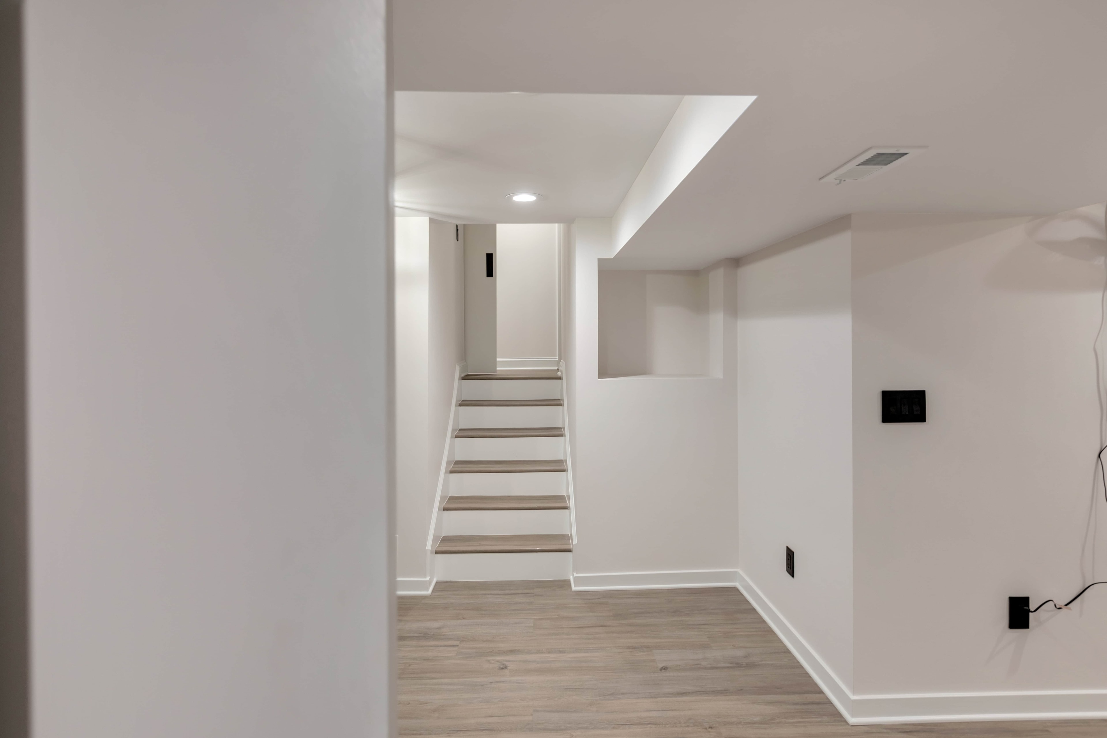 Full laundry room remodel Maryland — LG washer dryer, gray shaker cabinets, subway tile, matte black accents, eco-friendly design