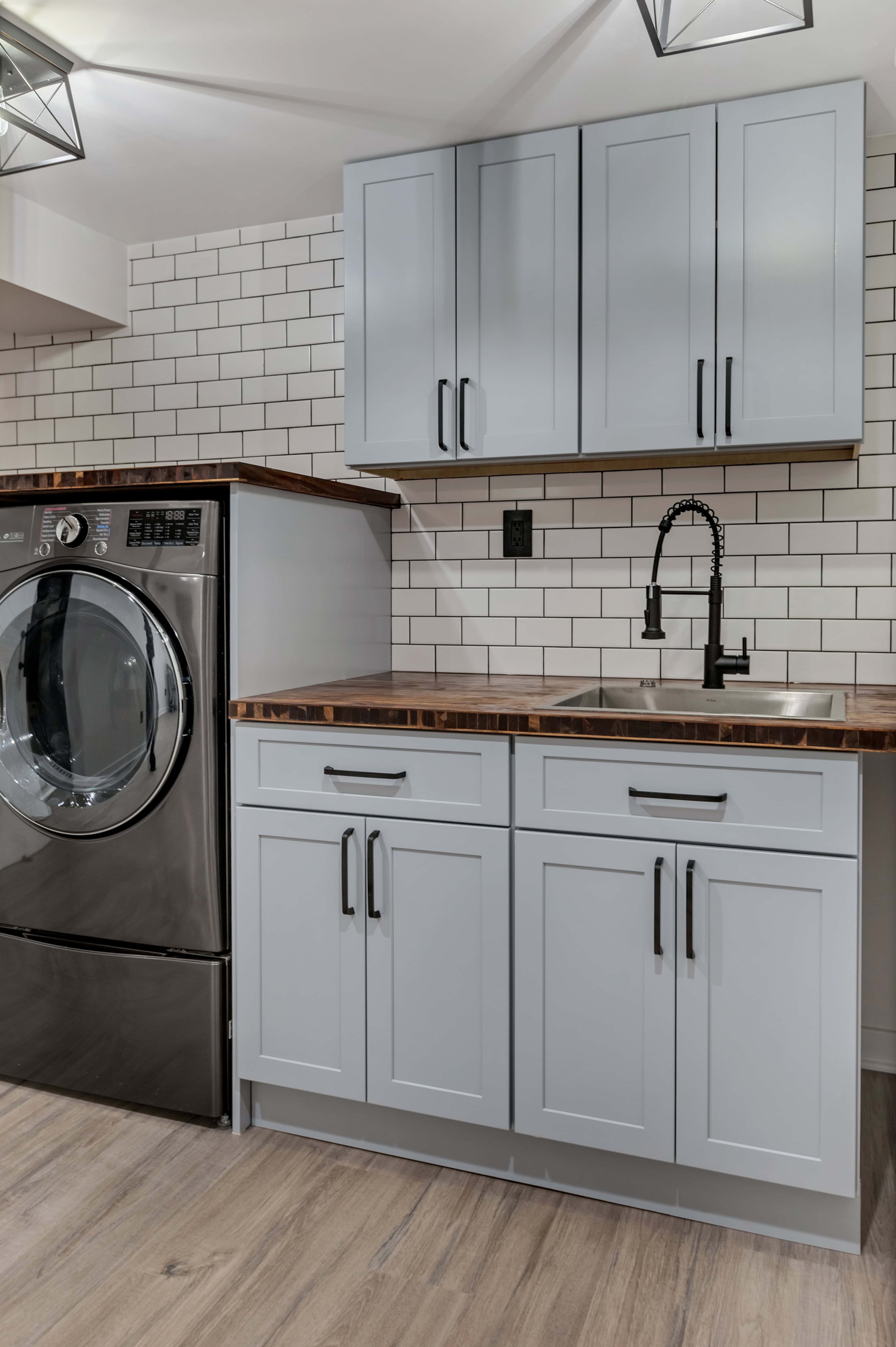 Gray shaker cabinet close-up — matte black hardware, butcher block counters, subway tile backsplash, eco-friendly laundry room Maryland