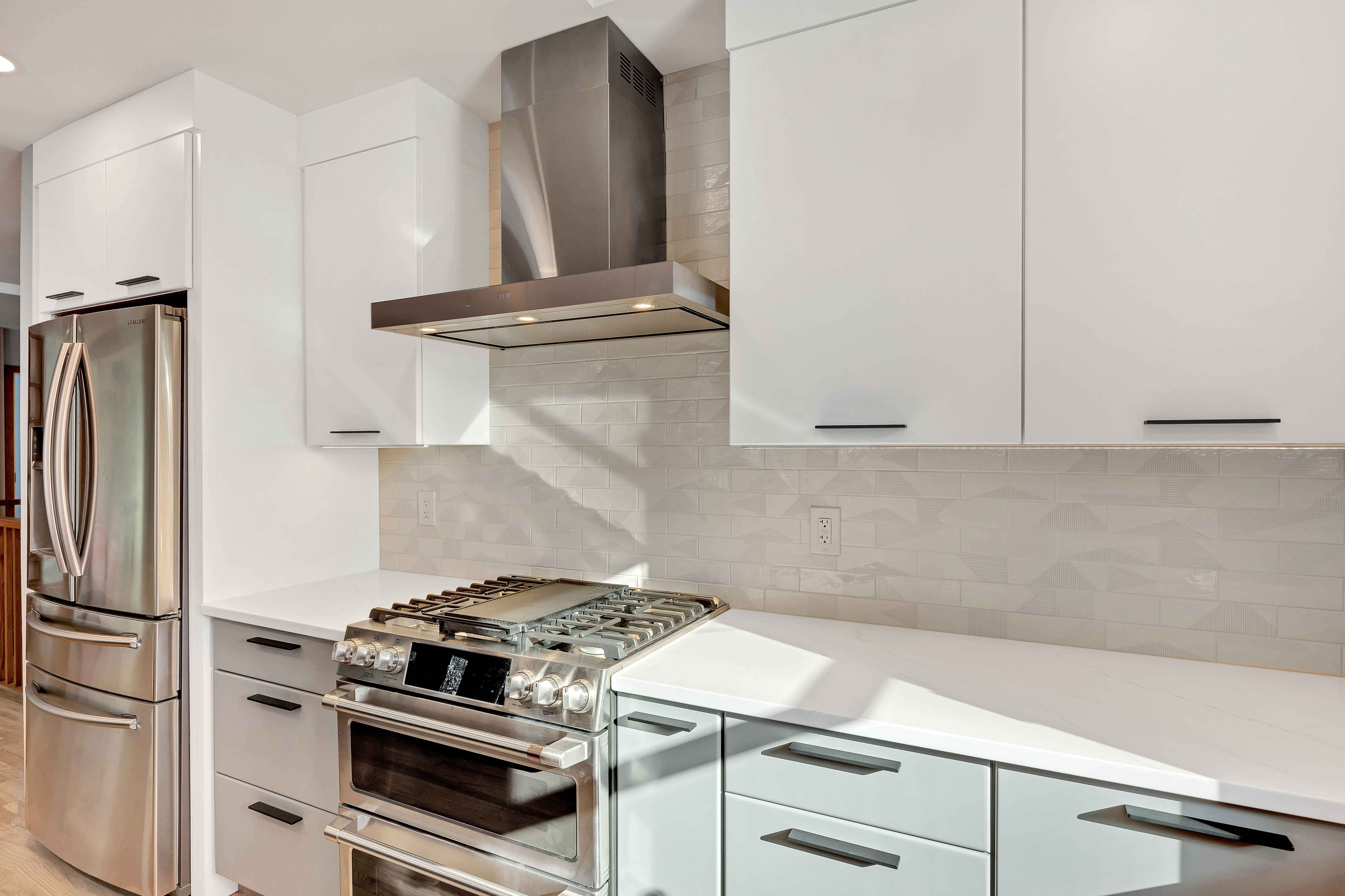 Open concept kitchen and dining renovation Maryland — white cabinets, stainless appliances, island seating, sustainable renovation by Alleco Center
