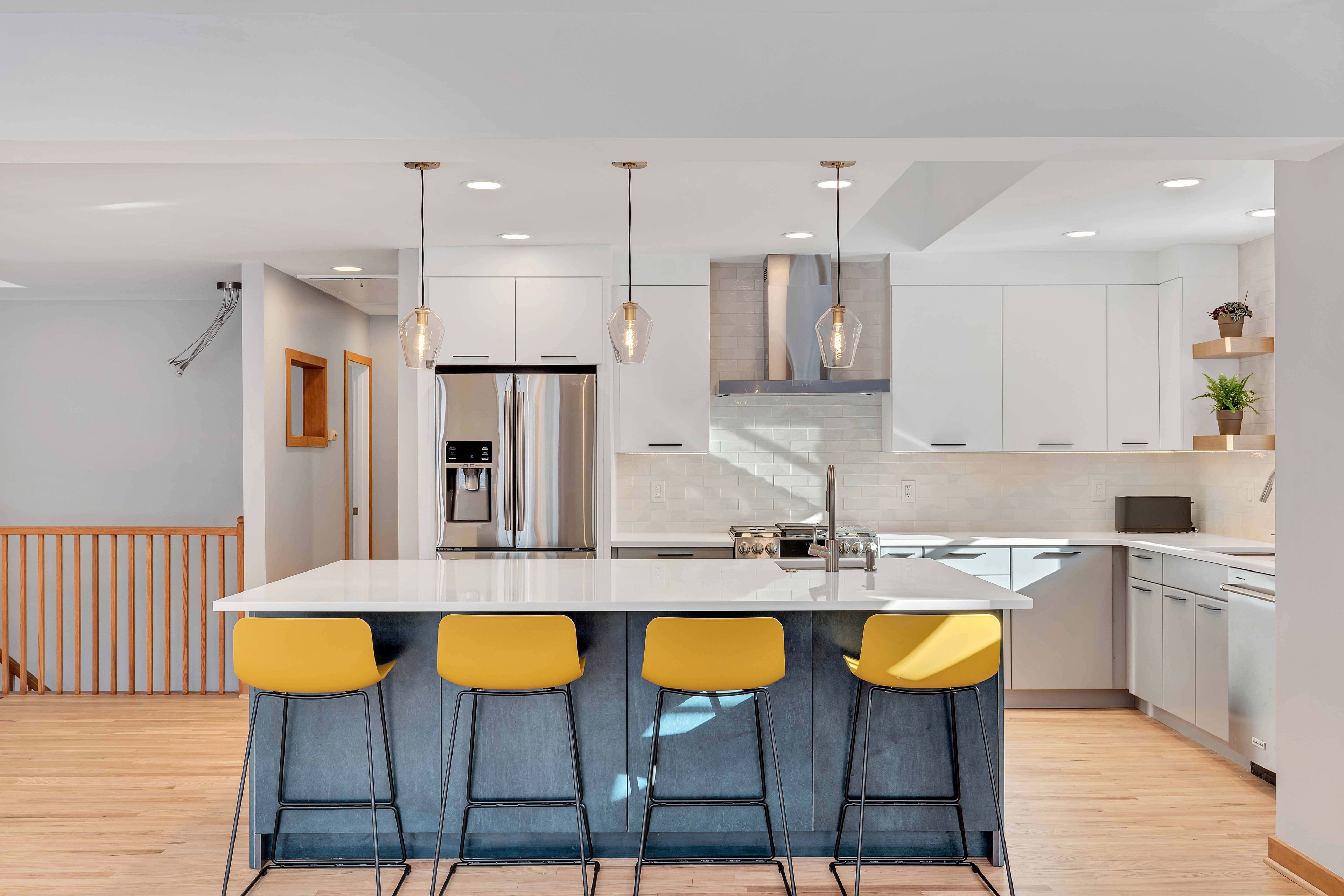 Kitchen range and hood detail Maryland — white subway tile, gray lower cabinets, stainless range, sustainable kitchen renovation